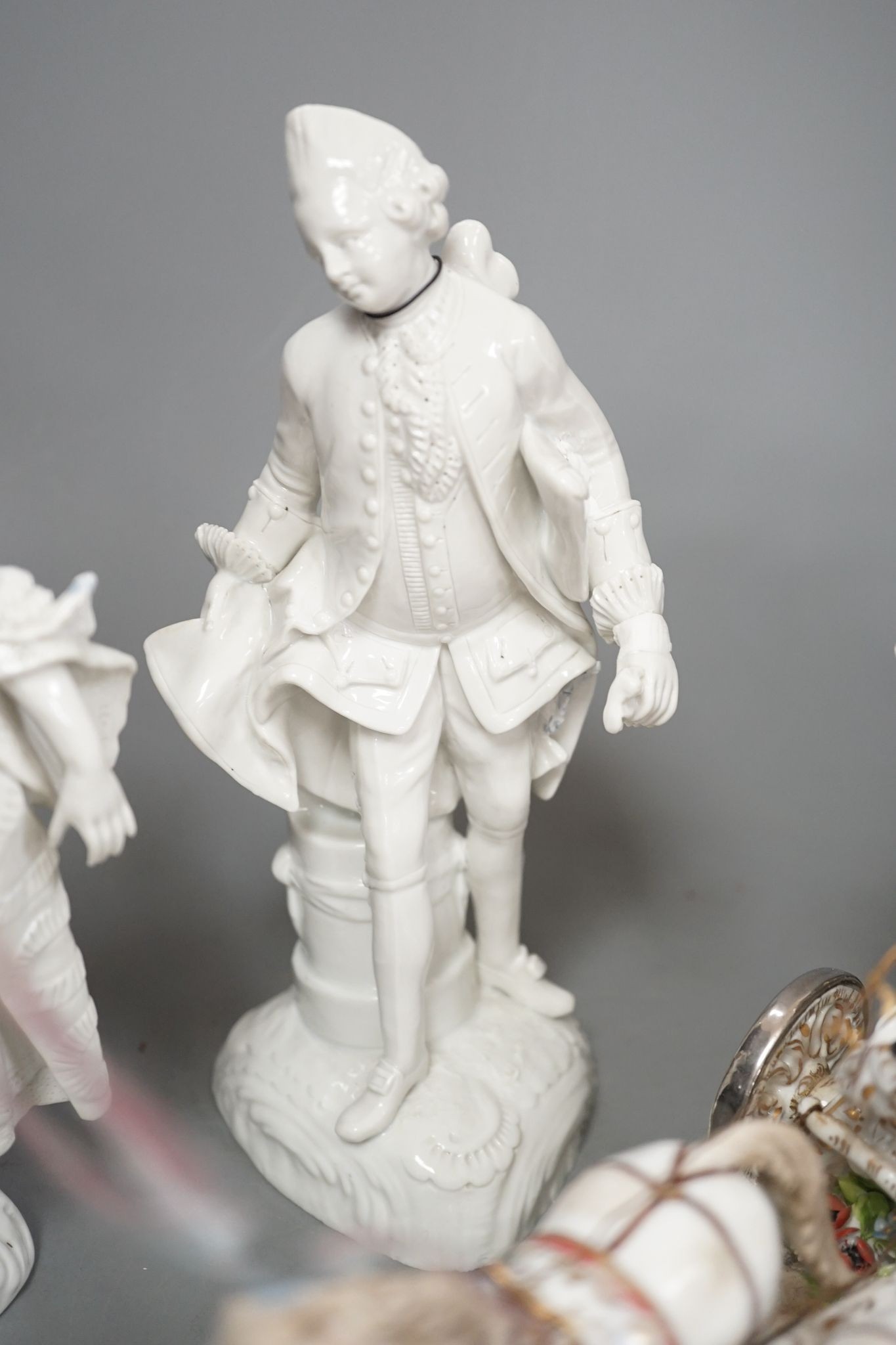 A large Italian porcelain carriage group and a pair of Italian white porcelain figure of a lady and a man 54cm
